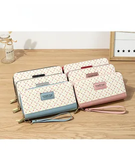 Detailed close-up of multi-color long zip wallets with classic pattern and wrist strap