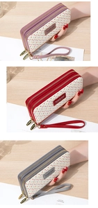 Close-up of long double zipper wallets with HR monogram pattern and wrist straps