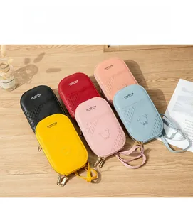 Collection of six colorful Korean style embroidered crossbody phone bags on a wooden table