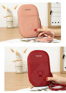Detail of crossbody phone bags with bear embroidery in pink and red tones