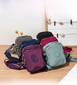 Detailed view of colorful multi-layer waterproof nylon crossbody phone bags with zippers