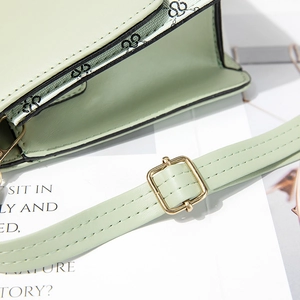 Mint green PU leather crossbody bag featuring gold buckle and stylish logo patterned trim