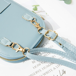Pale blue faux leather small crossbody phone bag with premium gold-tone hardware and straps