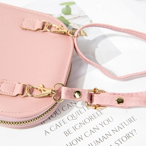 Pink faux leather crossbody phone bag for women with gold hardware and embroidery details