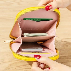 Yellow crossbody phone bag with zip closure showing internal card slots and compartments