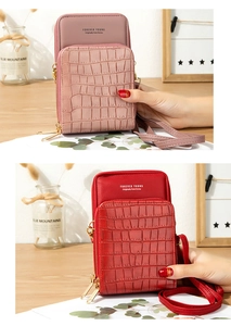 Detail of pink and red crossbody bags with stone texture and golden zipper closures