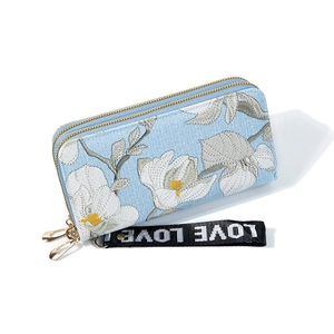 Light blue dual zipper wallet with floral embroidery and love strap in 45-degree view