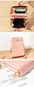 Detail of pink croc-textured phone wallet with card slots and golden zipper