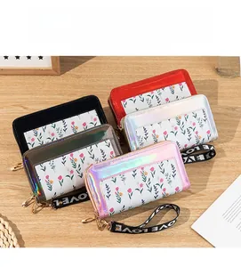 Close-up of long zip wallets in five colors with floral patterns and love wrist straps