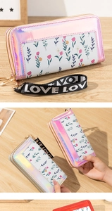Close-up of double-zipper laser floral wallet with LOVE wristlet and spacious compartments