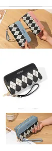 Detailed view of long double-zipper wallet with checkered pattern and wrist strap