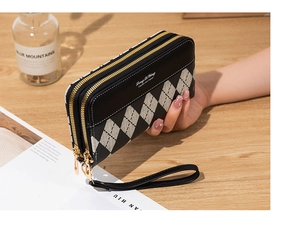 Close-up of long double zipper wallet with argyle patchwork and leather wrist strap