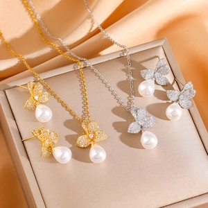 Elegant cubic zirconia flower and pearl jewelry set in gold and silver finishes