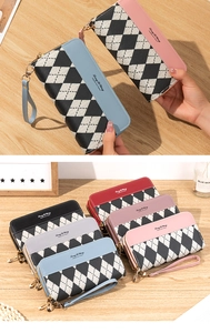 Detail of colorful argyle pattern wallets with double zippers and wrist straps