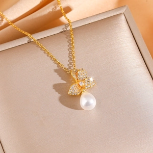 Elegant gold butterfly pearl necklace set with shimmering pavé zircon stones