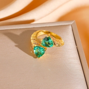 Vintage bypass ring with emerald green triangle stones and golden textured band
