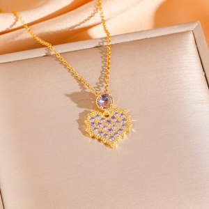Golden heart necklace with purple crystal pendant on an elegant silk background
