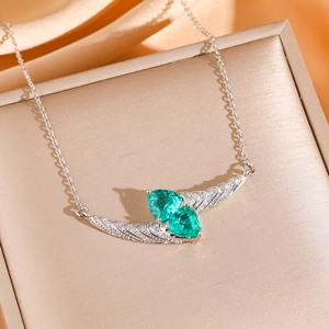 Elegant emerald double pear-cut diamond cross necklace in a premium jewelry gift box
