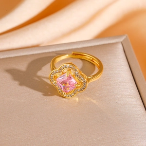 Detail of gold clover ring with square pink zircon and pave crystals on satin fabric