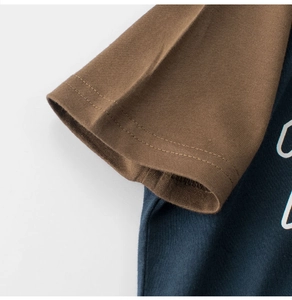 Close-up of raglan sleeve detail and neat stitching on kids color-block cotton t-shirt