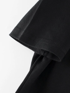 Close-up of black cotton kids T-shirt sleeve showing premium double-needle stitching