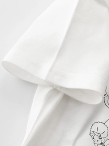 Close-up of kids' white cotton t-shirt with minimalist black dinosaur print detail
