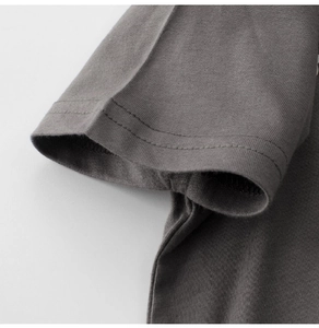 Close-up of boys' dark grey cotton t-shirt sleeve with double-stitch sewing details