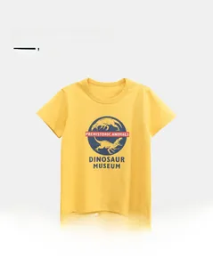 Close-up of bright yellow cotton t-shirt showing detailed dinosaur print and soft fabric