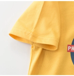 Macro view of yellow cotton t-shirt sleeve with high-quality double-needle stitching