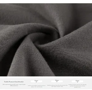 Detailed knit texture of children's grey cotton T-shirt with fabric safety standards info