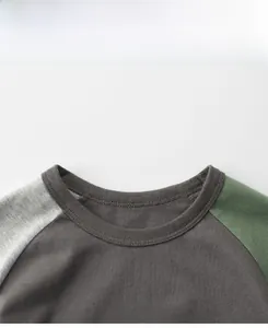 Detail of kids' short sleeve t-shirt featuring contrast patchwork sleeves and crew neck