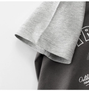 Detail of kids short sleeve raglan t-shirt with outdoor camp print and color block design