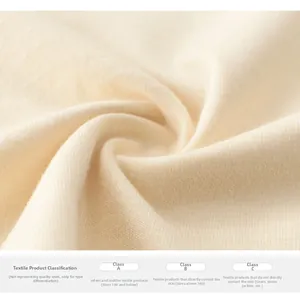Close-up of soft beige knit fabric showing textile safety standards and material texture