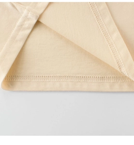 Macro shot of double-needle stitching and overlock hem on a cotton kids' t-shirt