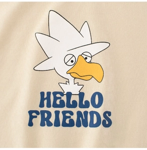 Close-up of beige cotton T-shirt featuring a cartoon bird print and Hello Friends text