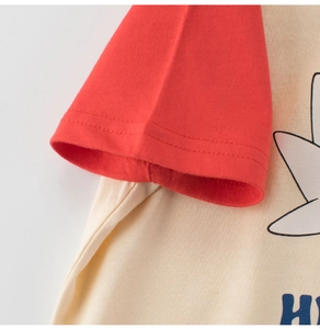 Close-up of kids raglan t-shirt featuring red sleeves and blue letter H print