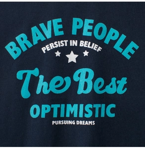Detail of printed motivational phrases and star patterns on blue cotton toddler T-shirt