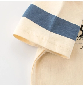 Close-up of boys' cream cotton t-shirt featuring navy striped sleeves and neat stitching