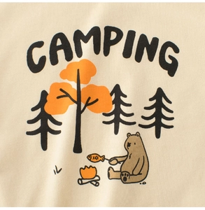 Detail of soft cream cotton kids T-shirt with camping bear and bonfire print