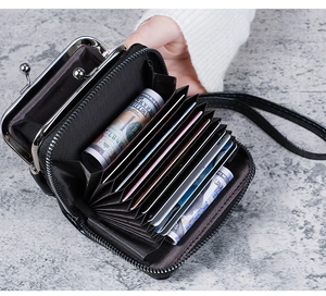 Detail of black multi-slot card holder and metal clasp coin purse with wrist strap