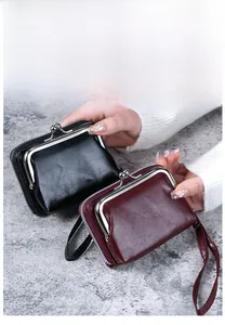 Macro detail of retro coin purses with metal clasp, zip pocket and wrist strap in two colors