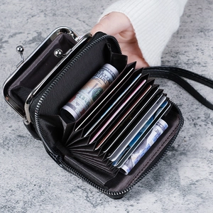 Black vegan leather accordion wallet with double compartments and wrist strap shown in hand