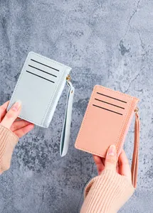 Detailed view of slim PU leather card holder with three card slots and wrist strap