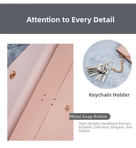 Detailed view of pink long wallet with rose gold metal snap button and key hook clasp