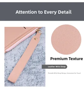 Detail view of pink leather card holder texture with wrist strap and zipper closure