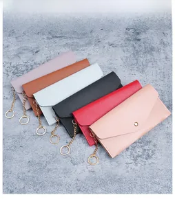 Detail view of long envelope wallets in six colors with metallic chain and snap closure