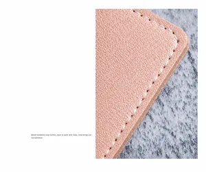 Close-up of pink pebbled leather card holder showing white precision stitching details