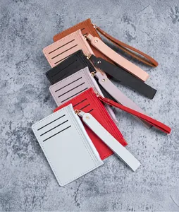 Flat lay of slim PU leather card holders in six colors featuring wristlets and zip pockets