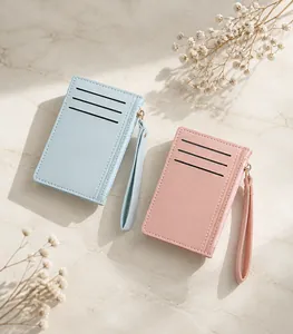 Slim card holder with wrist strap and zipper closure in mint green and pink faux leather