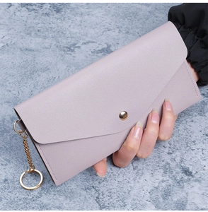 Close-up of litchi texture PU leather wallet with gold snap button and metal chain